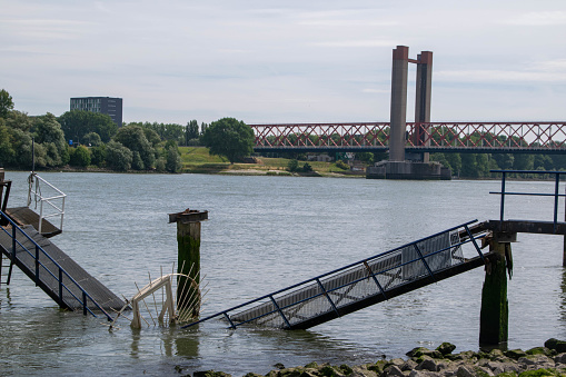 collapsed jetty in the Oude Maas near Spijkenisse with the Spijkenisserbrug in the background