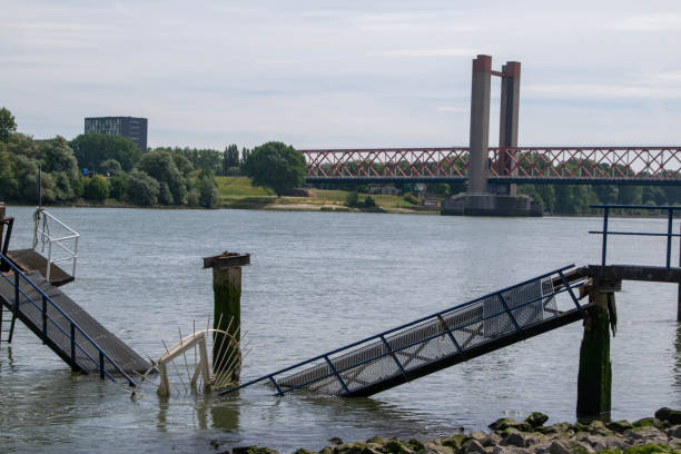 collapsed jetty in the Oude Maas near Spijkenisse with the Spijkenisserbrug in the background stock photo