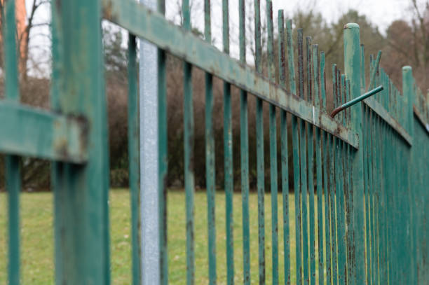 istock Rusty and weathered green painted metal fence 1412619301