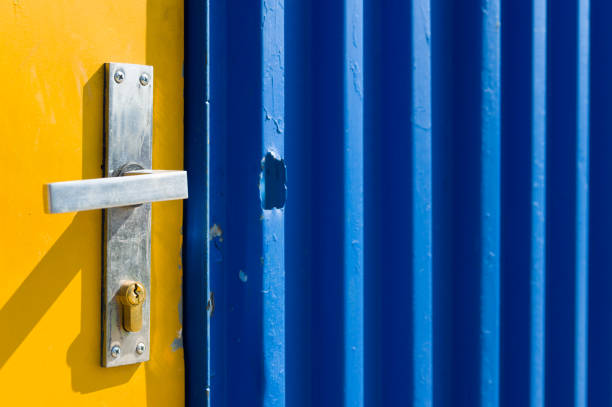 istock Bright yellow and blue painted door on a construction site 1412619390