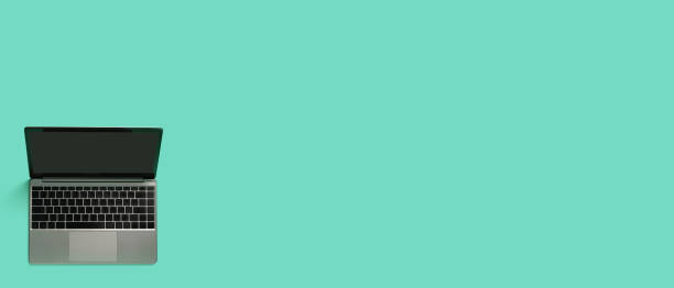istock Top view of modern laptop isolated on colored background. Copy space 1412620559