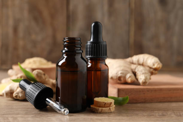istock Ginger essential oil in bottles on wooden table 1412621189