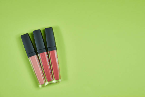 istock three lipsticks of different colors pattern on a green background isolated 1412621516