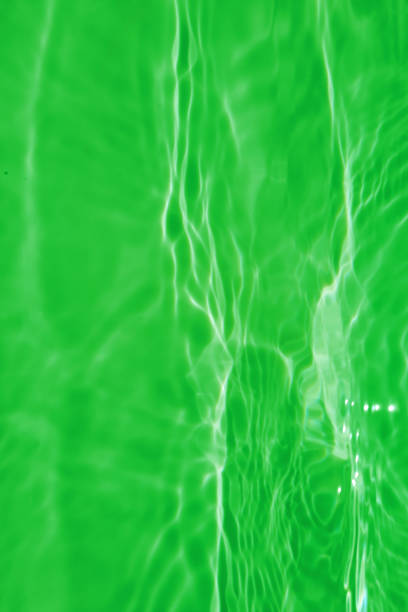 istock Defocus blurred transparent green colored clear calm water surface texture with splashes and bubbles. Trendy abstract nature background. Water waves in sunlight with copy space. Blue watercolor texture 1412622855