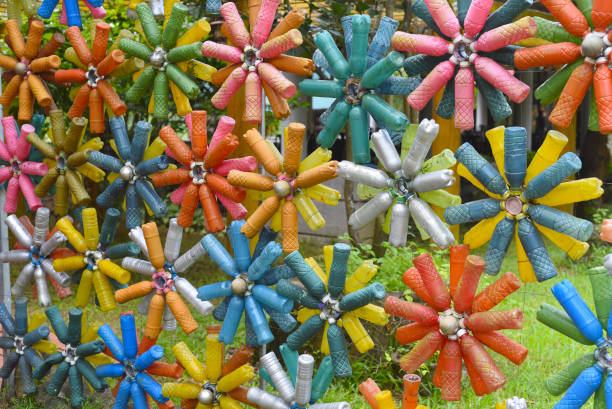 Flower shaped colourful decorations made of plastic bottles stock photo