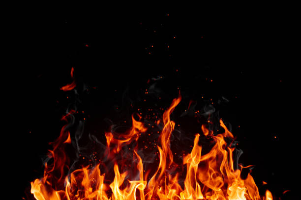 Blazing flame of fire with bright sparks isolated on black background stock photo