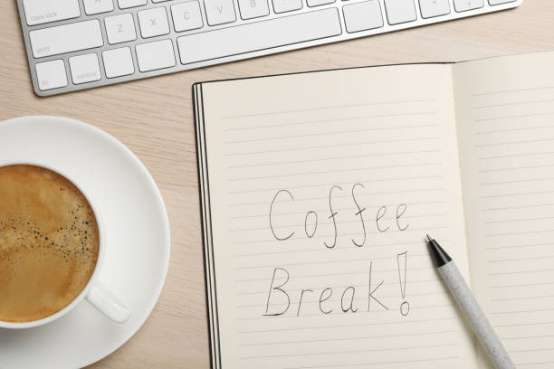 istock Notebook with phrase Coffee Break, cup of drink and keyboard on wooden table, flat lay 1412625364