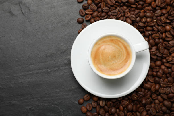 istock Cup of hot drink and beans on black table, top view with space for text. Coffee Break 1412625462