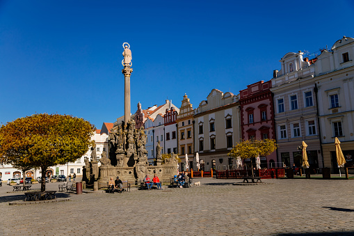 Pardubice, Czech Republic, 17 April 2022: Main Pernstynske square with townhall and baroque Plague or Marian column, colorful renaissance historical buildings at medieval center at sunny day