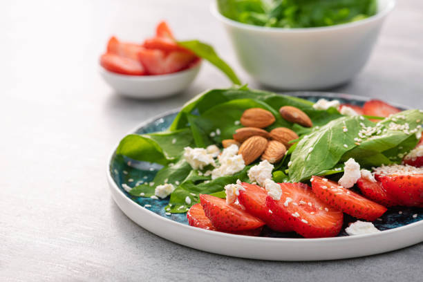 istock Fresh salad with strawberry fruit, almond, spinach and cottage cheese 1412629225