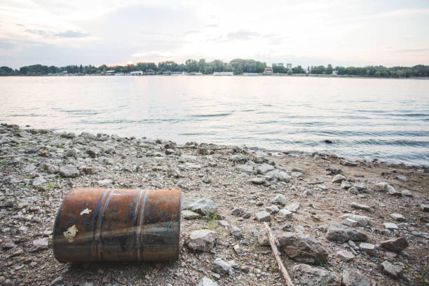 Risty steel barrel rusting at river shore