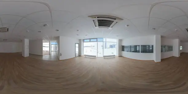 Photo of Seamless full spherical 360 degree panorama in equirectangular projection of empty small office room in industrial building