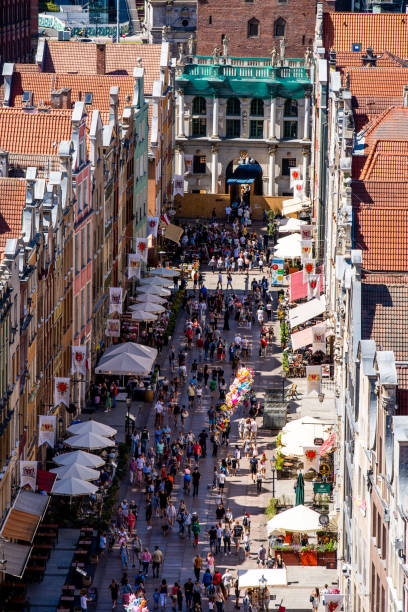 Długa street (Ulica Długa) in the centre of Gdansk old town. Old town of Gdansk, Srodmiescie historic district - tourists strolling along the Dluga street and chilling in cafes. gdansk city stock pictures, royalty-free photos & images