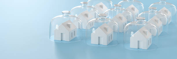 istock Proptecting your property concept - insurance, surveillance. Several model houses with glass domes. Web banner format 1412631376
