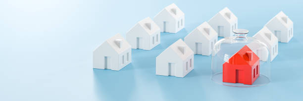 istock Proptecting your property concept - insurance, surveillance. Several model houses, one in red with a glass dome. Web banner format 1412631404