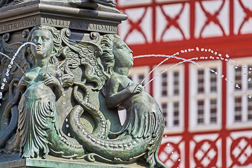 Close-up detail of a metal statue of a lion holding a globe in front of the Congress of Deputies, Madrid, Spain. Travel and landmark editorial concept.
