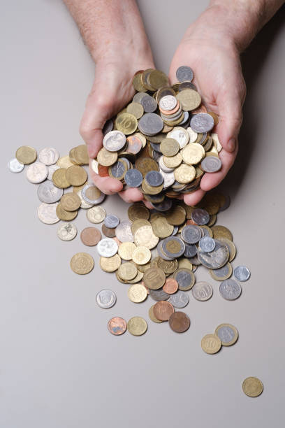 istock Hands elderly woman holding coins. 1412633042