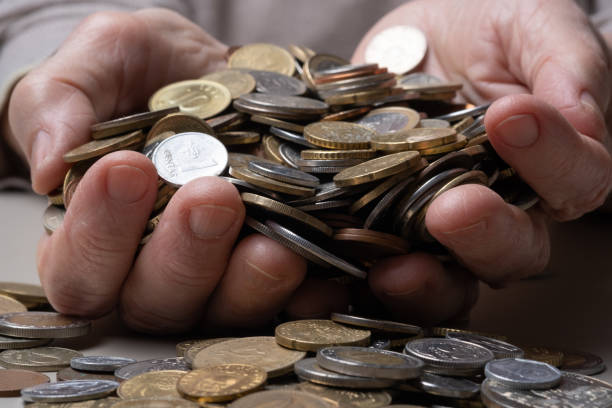 istock Hands elderly woman holding coins. 1412633085