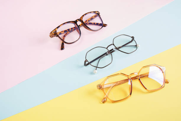 istock multiple eyeglasses on a multicolored background of pastel colors, geometric background, pink yellow and light blue colors, trendy eyeglass frames 1412635528