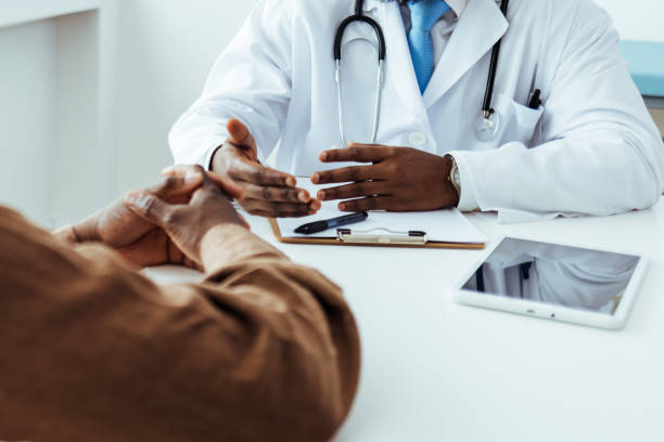 istock Caring doctor listens to patient 1412635550