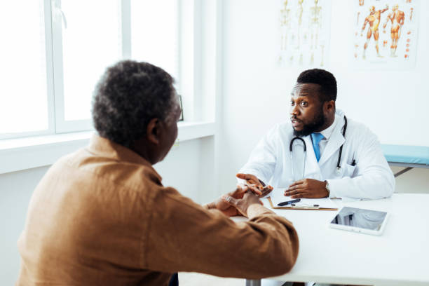 istock Young doctor with elderly patient 1412635564