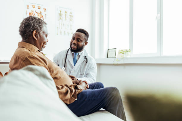 Male doctor talking while explaining medical treatment while prescribing medication to patient in the consultation. Male doctor talking while explaining medical treatment while prescribing medication to patient in the consultation. doctor prescribing stock pictures, royalty-free photos & images
