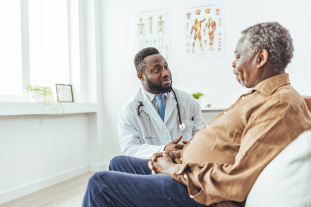 istock Friendly smiling young doctor supporting older patient during visit 1412635596