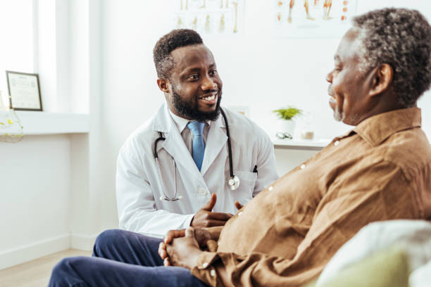 Doctor talking to a patient in a consultaton at the office stock photo