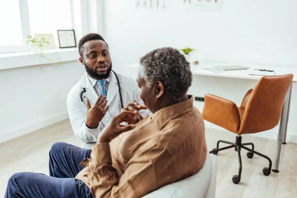 Photo of Senior man looks at doctor in disbelief