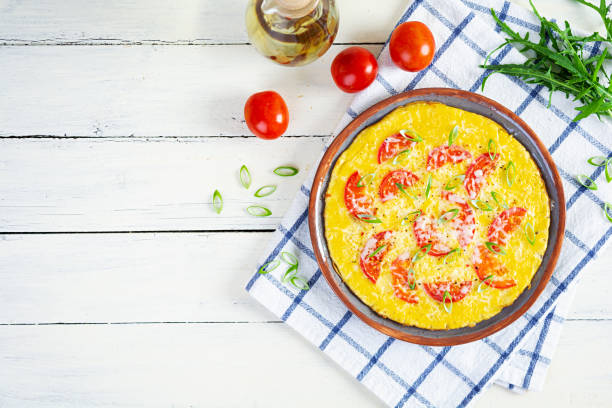 istock Omelette with tomatoes, herbs and grated cheese. Easy breakfast 1412636529