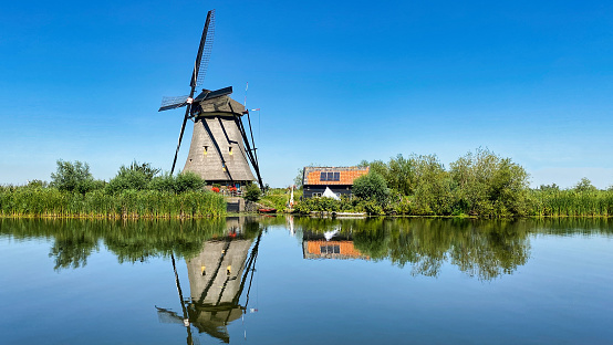Historic windmill in winter landscape in Groningen, Netherlands