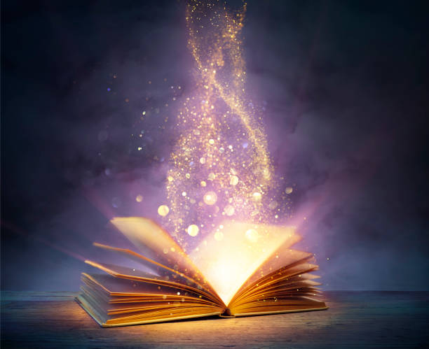 magic book with open pages and abstract lights shining in darkness - literature and fairytale concept - boek stockfoto's en -beelden