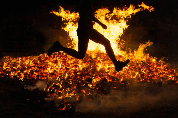 istock Summer solstice celebration jumping into the fire. Burning flames 1412637261