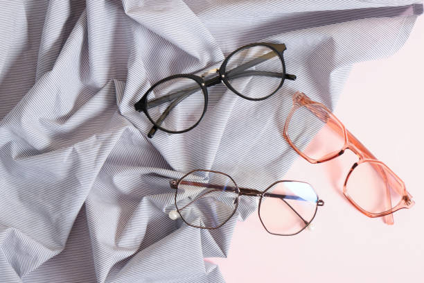 istock stylish eyes glasses on striped fabric on pink background copy space 1412638209