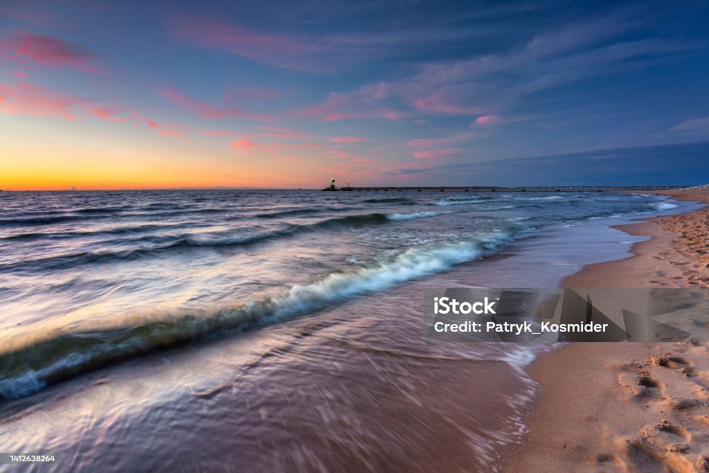 Sunset on the beach of the Baltic Sea in Gdansk, Poland Baltic Sea Stock Photo