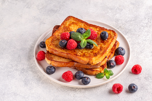 French toast with blueberries, raspberries, maple syrup, morning breakfast.