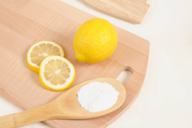 istock lemon and baking soda on wooden spoon, knitting board 1412643195