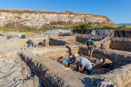 Yunatsite, Bulgaria - August, 02 2022: Archaeologists are working at Tell Yunatsite dig site.