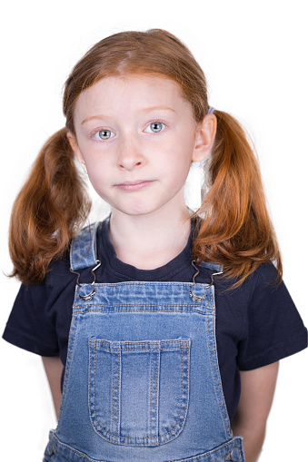 Eight year old girl with her red hair tied in bunches.