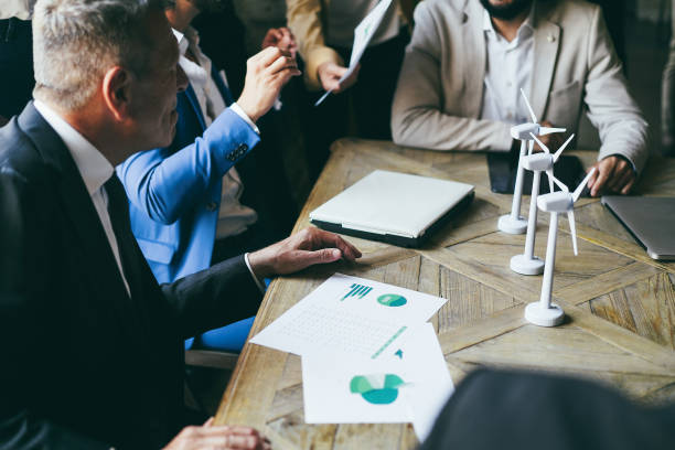 istock Business people working on sustainable innovation project - Focus on senior man hand 1412644827