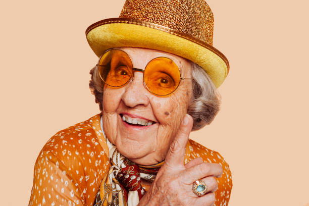 istock Old funny grandmother wears hat at studio 1412645074