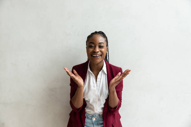Portrait of young successful expert freelancer CEO African American woman with happy face. Business female satisfied with project showing her new ideas success  facial expressions stock photo