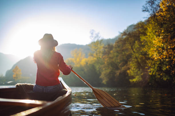 istock Woman enjoying perfect day on canoe 1412646486