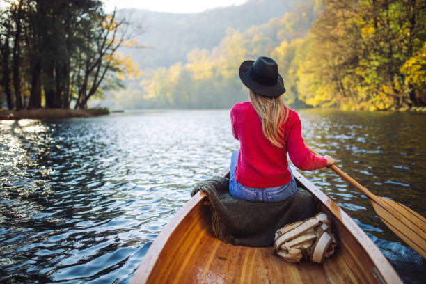 istock Woman enjoying perfect day on canoe 1412646497