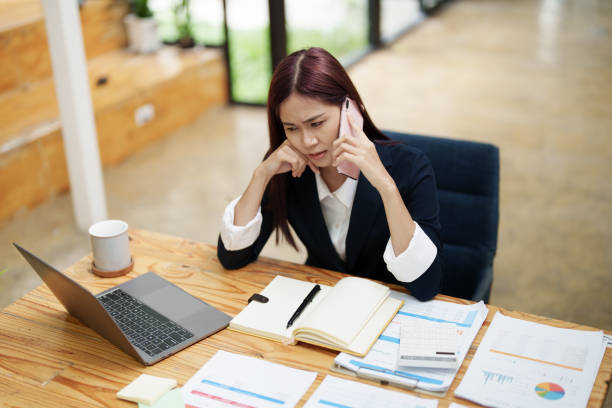 istock businesswoman showing a serious expression while talking on the phone 1412646585
