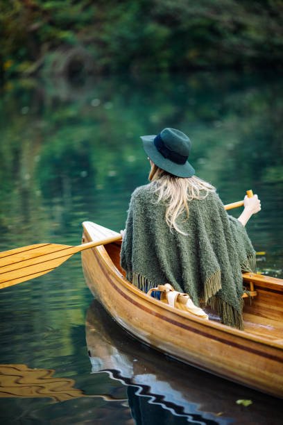 istock Woman enjoying perfect day on canoe 1412647384