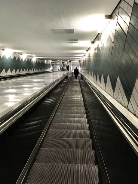 istock Deep escalator at a modern metro station 1412648118
