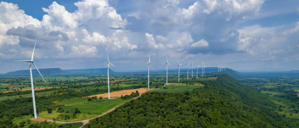 Wind turbine farm power generator in beautiful nature landscape for production of renewable green energy is friendly industry to environment. stock photo