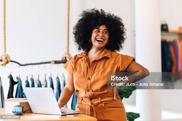 Ethnic Small Business Owner Smiling Cheerfully In Her Shop Stock Photo - Download Image Now