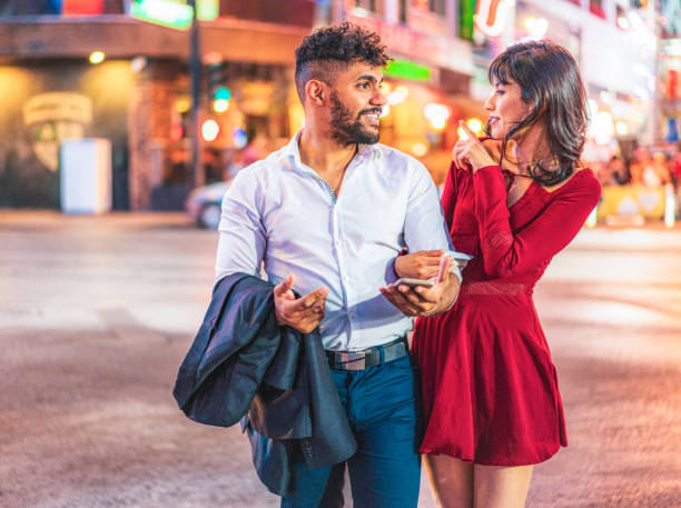 istock Couple having fun in Vegas 1412652238